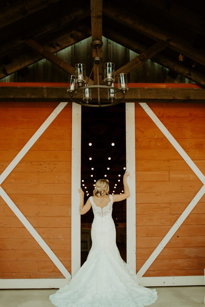 bride in front of barn doors
