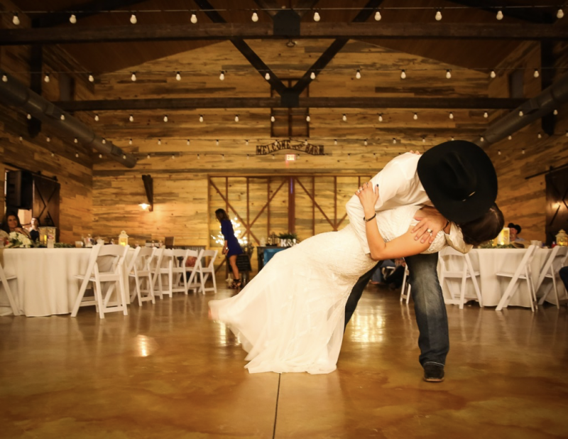 dip kiss at barn wedding