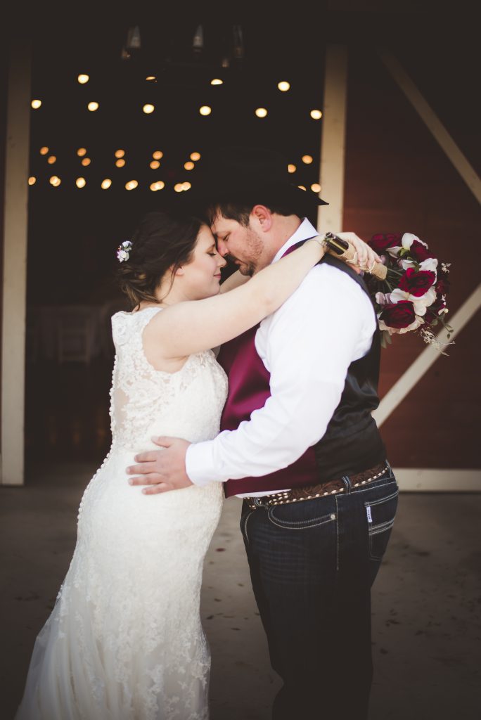 newlywed portrait in front of the barn at the silver spur resort